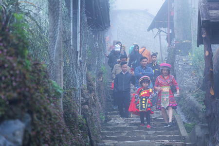 Sapa, Vietnam - March 7, 2019 : View of people traveling at Cat Cat village, in the rainy and foggy morning Laocai province, Sapa, Vietnam.のeditorial素材