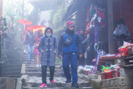Sapa, Vietnam - March 7, 2019 : View of people traveling at Cat Cat village, in the rainy and foggy morning Laocai province, Sapa, Vietnam.のeditorial素材