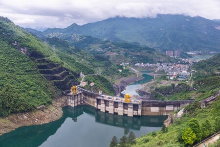Dam wall and surrounding landscape at Wulong Dam in Chongqing, China. during summer with a low water level on a clear sunny day.の写真素材