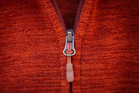 Zip zipper close up macro on red clothes background.の写真素材