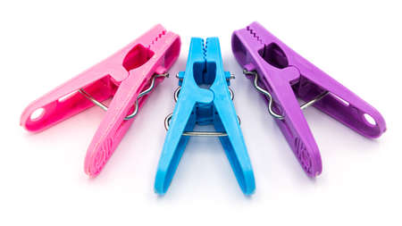 Colorful plastic clothespins or clothes pegs isolated on white backgroundの写真素材