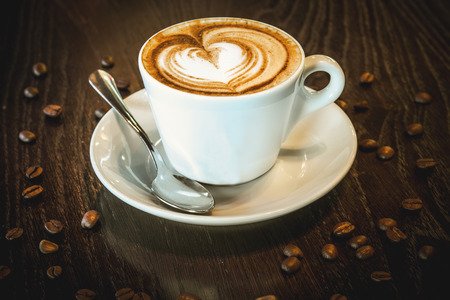 Cup of coffee on the oak tableの写真素材