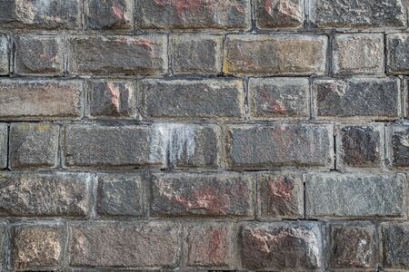 wall of colored hewn rectangular and square stones