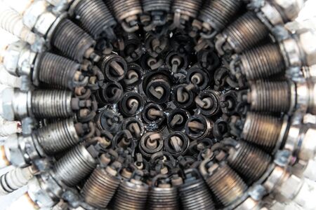Old spark plugs arranged in a circle at a shallow depth of fieldの写真素材