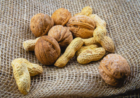 handful of walnuts and peanuts located on sackingの写真素材
