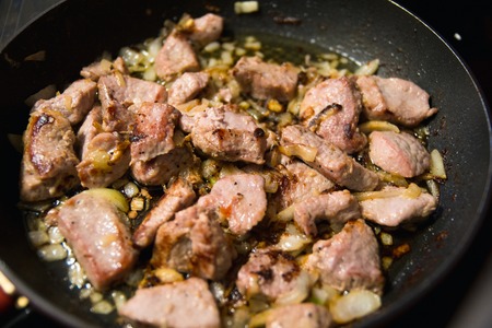meat fried with onions in a panの写真素材