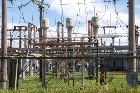 high voltage wires and insulators power station against the blue sky