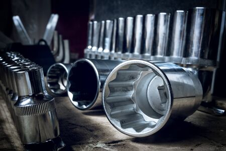 Tool head against the background of a similar tool with shallow depth of field