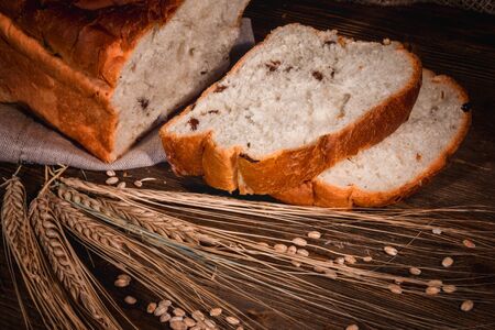 sliced white buns and ears of wheat close