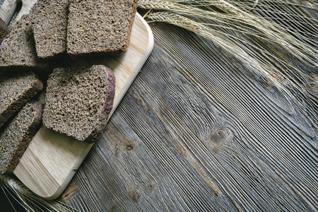 pieces of wholemeal bread on board with shallow depth of fieldの写真素材
