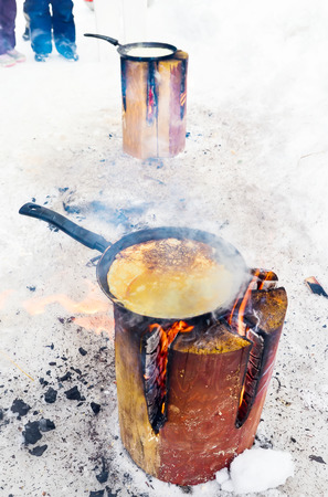 Cooking pancakes on the fire with a small depth of fieldの写真素材
