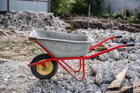wheelbarrow on the background of construction debris