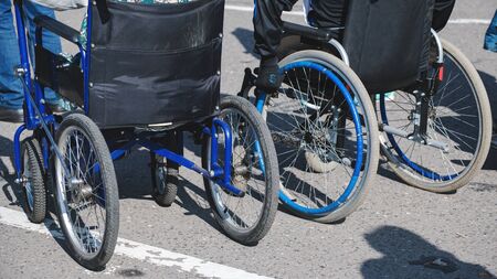 wheelchair wheels closeup on asphaltの写真素材
