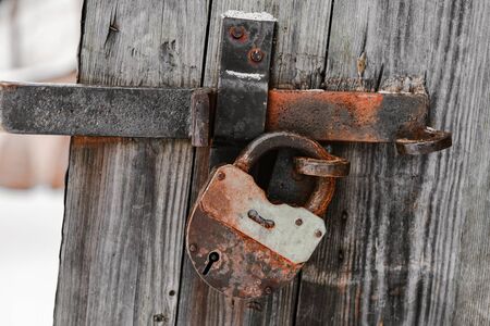 Old lock on a wooden door with shallow depth of fieldの写真素材