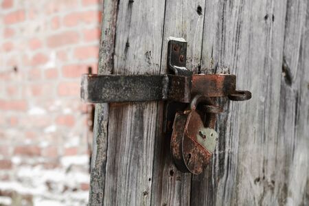 old lock on a wooden door with shallow depth of fieldの写真素材