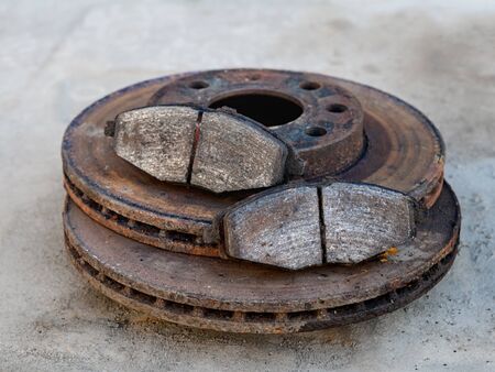 old brake pads on the brake disc with a shallow depth of fieldの写真素材
