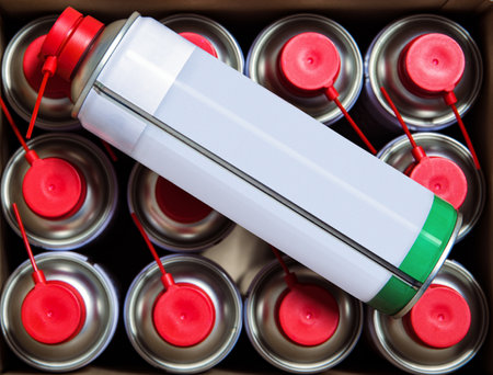 spray can on multiple cans in a box with caps on the spray at shallow depth of fieldの写真素材