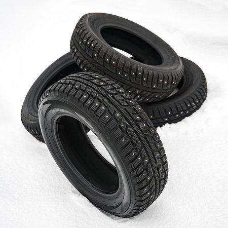 winter car studded tire on snow with shallow depth of fieldの写真素材
