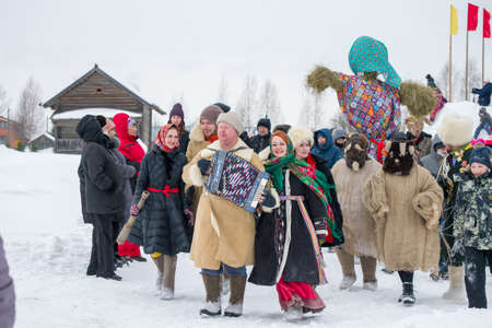 Village of Semenkovo, Vologda, Russia - March 13, 2021: Holiday of Shrovetide in Russia. People carry a doll to be burnedのeditorial素材