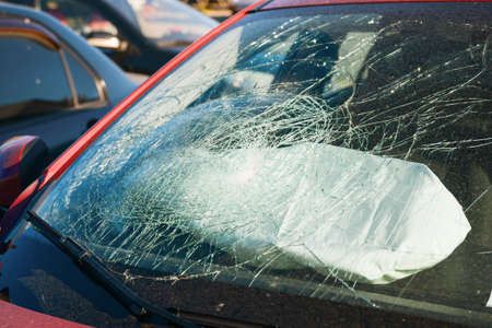 broken windshield of a car from a shot of an airbag at a shallow depth of fieldの写真素材
