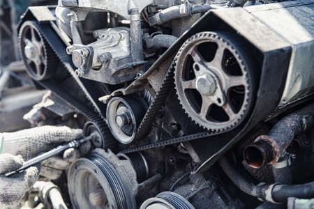 the car engine is disassembled from the side of the belt and the timing rollers at a shallow depth...