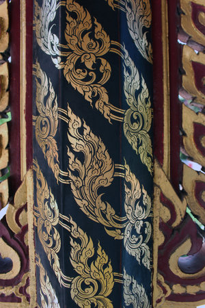 Thai style molding art on the wall at the temple.の写真素材