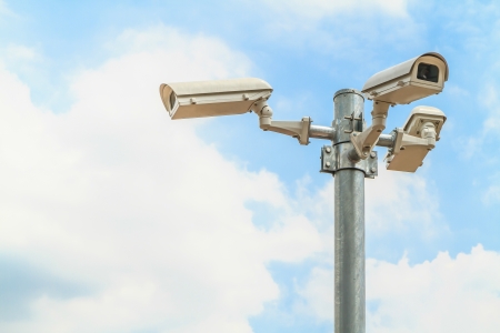 Security camera on blue sky backgroundの写真素材