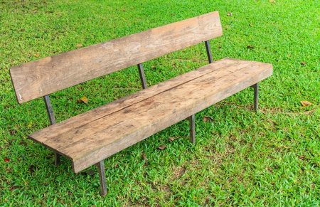 A wooden bench in green parkの写真素材