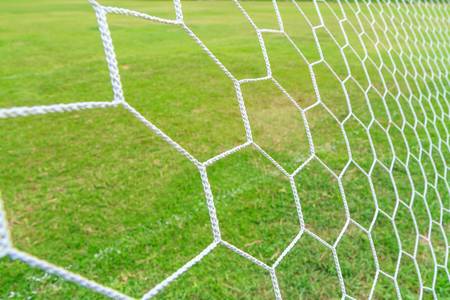 Soccer Goal Net with Green Grass Backgroundの写真素材
