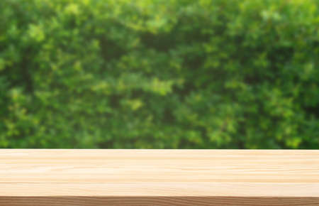 wooden floor and fresh green leaves background.concept for eco