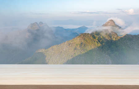 wood floor for product design display with doi luang chiang dao mountain view at morning fog backgroundの写真素材
