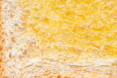 close-up macro sweet magarine butter on slice of bread texture background.concept idea for dairy product,breakfast or lunch meal,bakery cooking.の写真素材