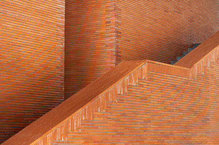 modern architecture building exterior wall panel with orange brown block brick texture pattern.