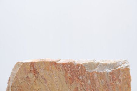 empty natural rough beige granite stone podium on white background with blank space.cosmetic beauty fashion product present placement pedestal promotion display,mock up minimal concept.の写真素材