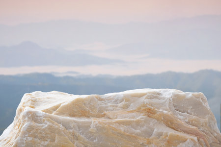 Stone podium table top with outdoor mountains pastel color scene nature landscape at sunrise blur...
