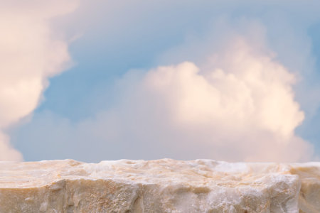 Stone podium tabletop floor in outdoor on sky pink gold pastel soft cloud blurred background.Beauty cosmetic product placement pedestal present promotion stand display,summer paradise dreamy concept.の写真素材