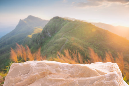Stone podium outdoors on golden sky sunset with beautiful misty mountain nature landscape background.Cosmetic product placement pedestal present stand display,summer paradise concept.の写真素材
