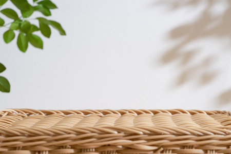 Wooden rattan podium table top blurred green leaf plant on white space nature background.Beauty cosmetic natural product display.の写真素材