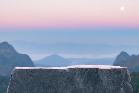 Surreal stone podium outdoors on sky pink pastel soft cloud sunrise with misty mountain nature landscape background.Beauty cosmetic product placement pedestal present minimal display,paradise dreamy concept.の写真素材