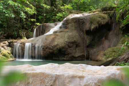 Stone table top podium floor in outdoor waterfall green tropical forest nature background.Natural water product present placement pedestal counter display, spring summer jungle paradise concept.の写真素材
