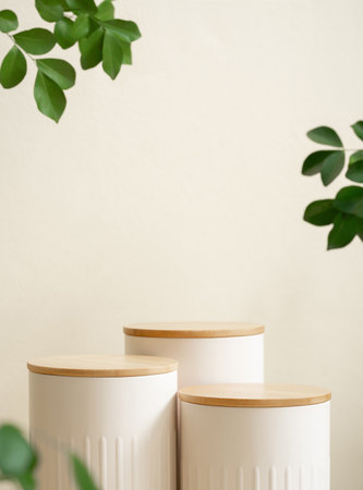 Minimal wood white podium with blurred green leaf plant on beige background.Beauty cosmetic natural mild product modern display,nature eco friendly concept.の写真素材