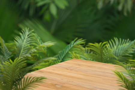 Wood podium table top floor in outdoors tropical garden forest blurred green leaf plant nature background.Natural product placement pedestal stand display,jungle paradise concept.の写真素材