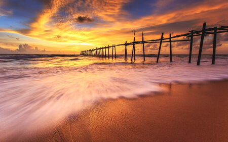Long wood bridge with Sunrise in Thailandの写真素材