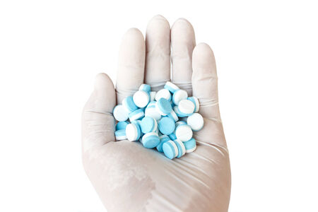 Hand holding medicine , isolated on white backgroundの写真素材