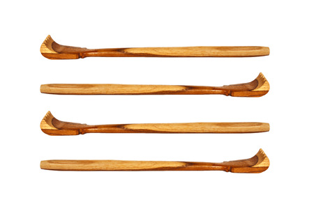 Thai handcraft of wooden backscratcher, isolated on white background の写真素材