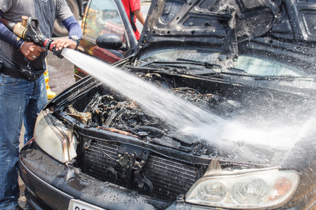 firemen extinguishing a car fire の写真素材