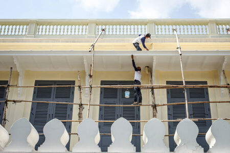 Worker painting on the buildingの写真素材