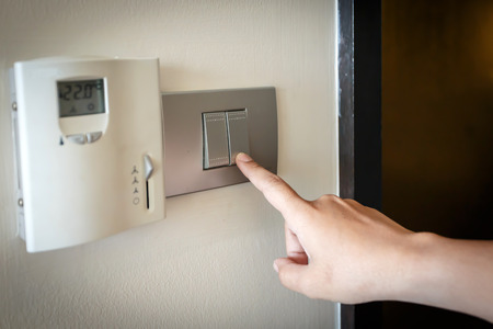 hand pressing electronic-light switch