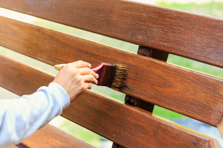hand holding brush and paint timberの写真素材