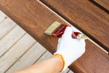 hand holding brush and paint timberの写真素材
